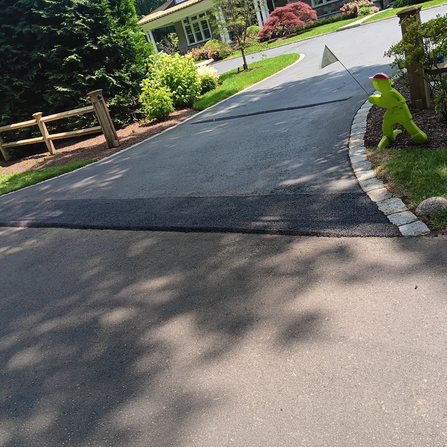 Freshly paved curved residential driveway