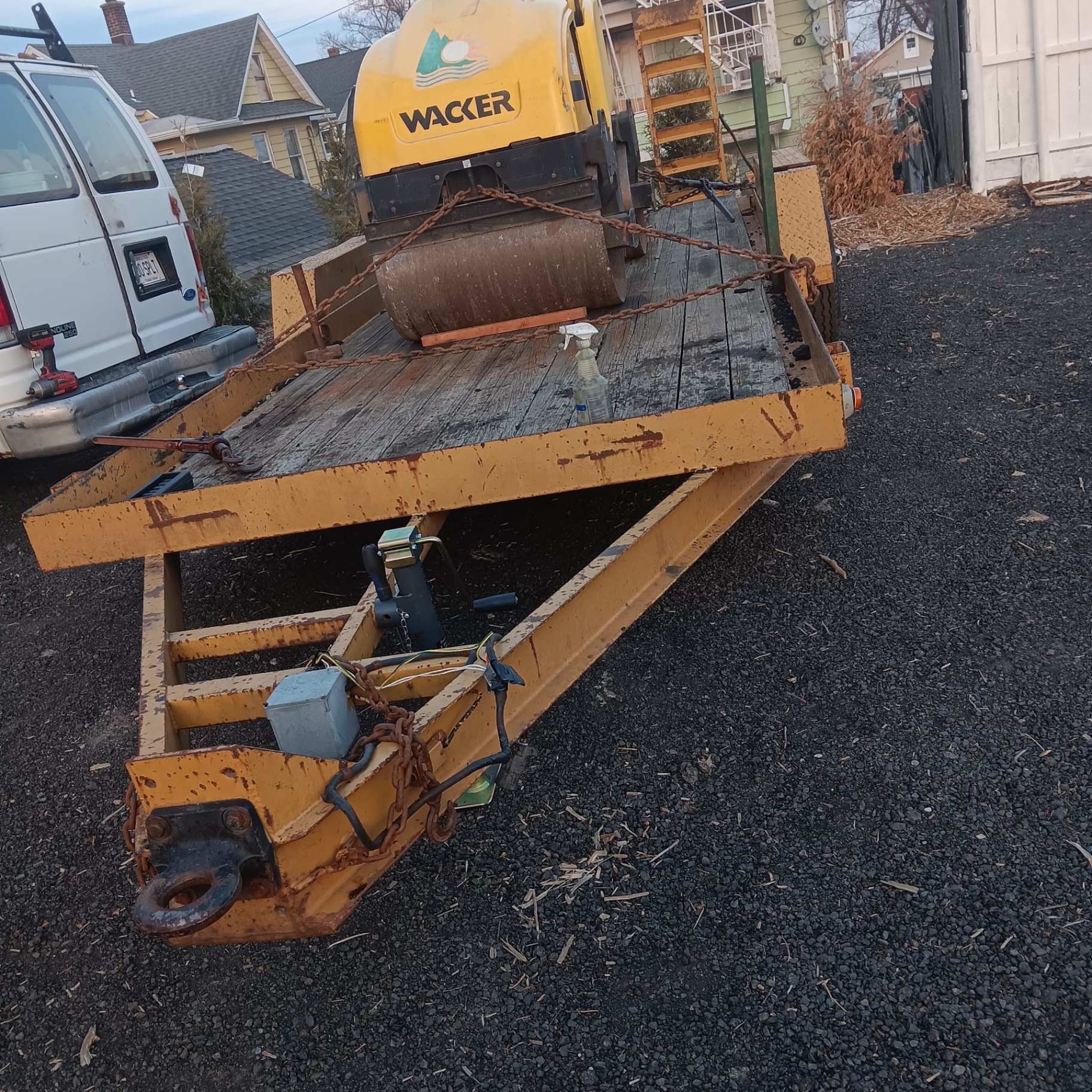 Compactor roller loaded on equipment trailer