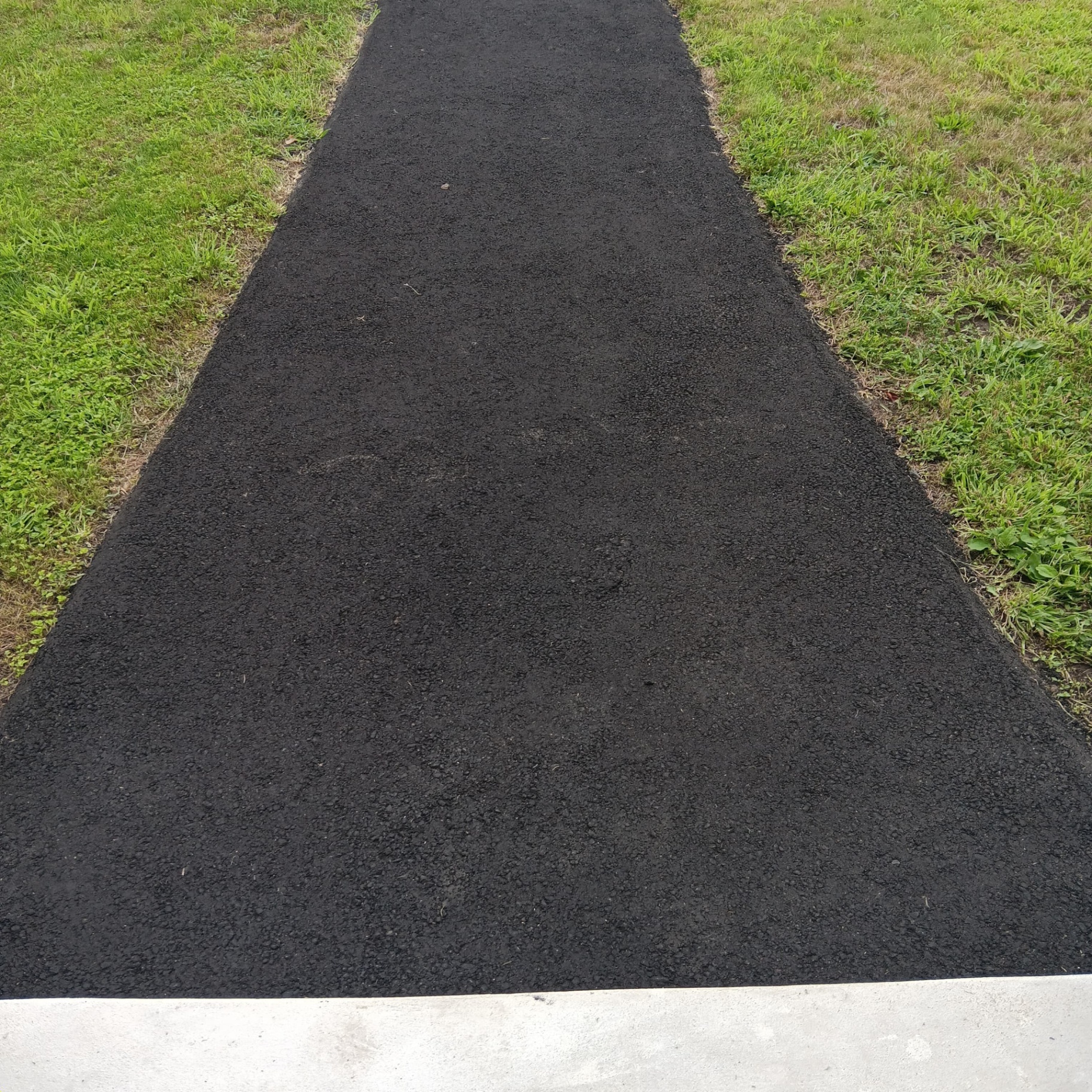 Fresh asphalt pathway installation
